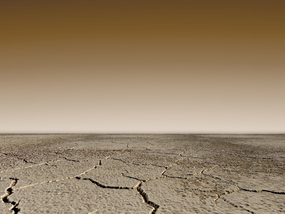 Dry landscape in sepia shades with cracks on the ground