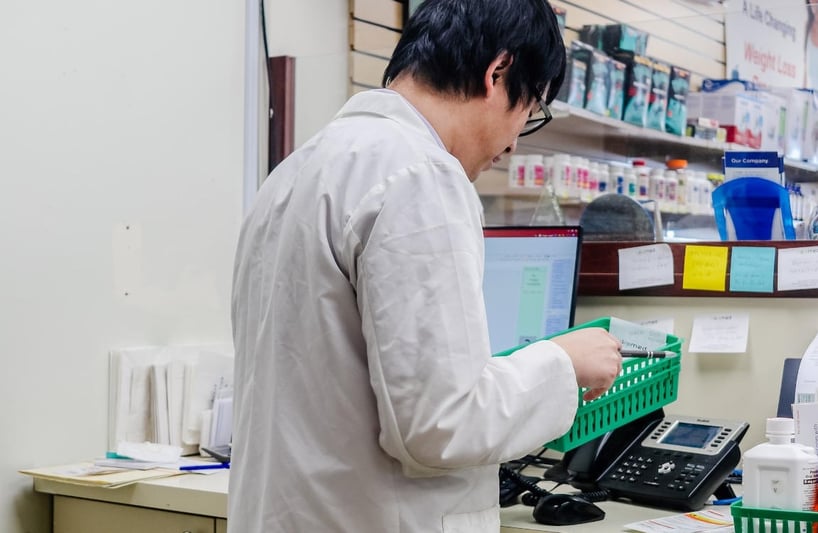 a pharmacist working behind the counter
