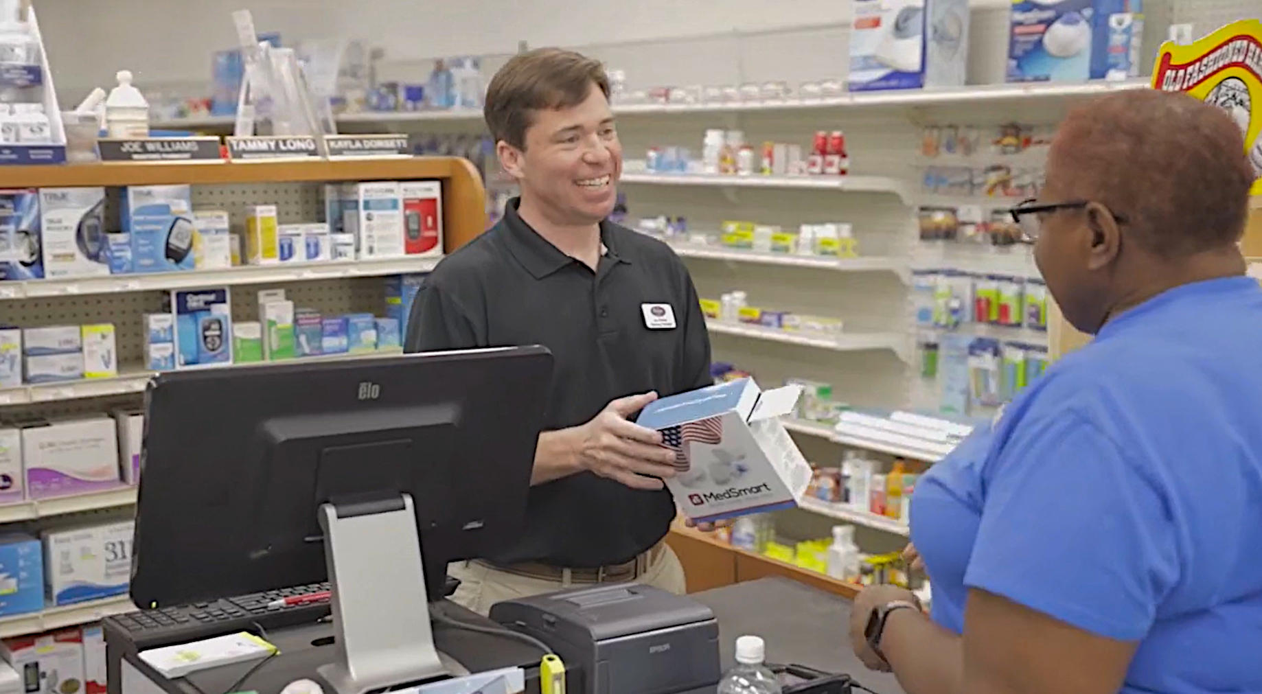 Smiling pharmacist and customer discussing a product in the pharmacy