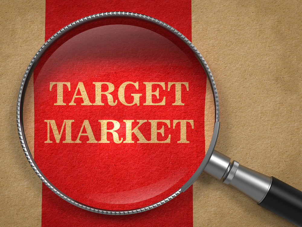 Target Market - Magnifying Glass on Old Paper with Red Vertical Line.