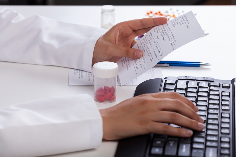 Pharmacists hands checking information about medicines